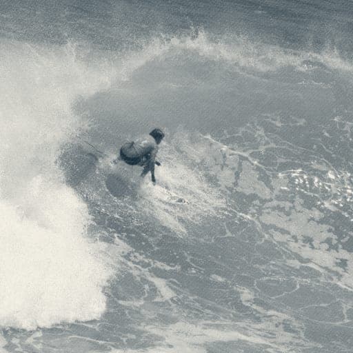 Ryan Ragan in a contest jersey snapping on a turquoise wave