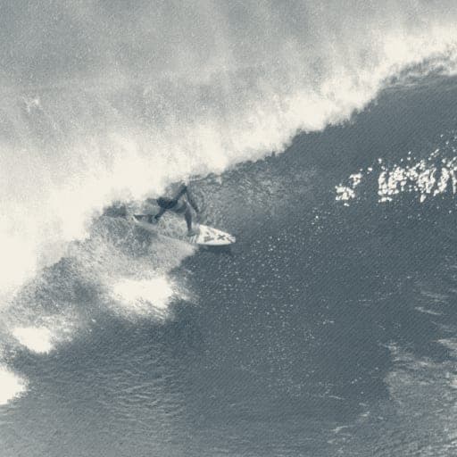 Ryan Ragan setting his rail on a glassy overhead emerald wave face